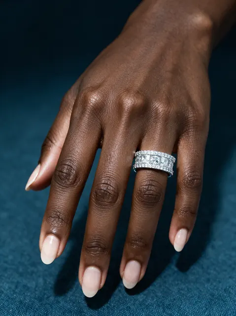 AI on hand image: eternity band teal, made by Grandior AI Studio