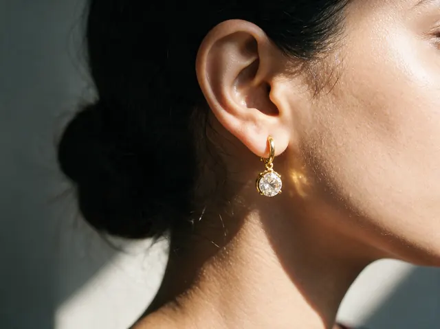 AI on ear image: gold drop, made by Grandior AI Studio