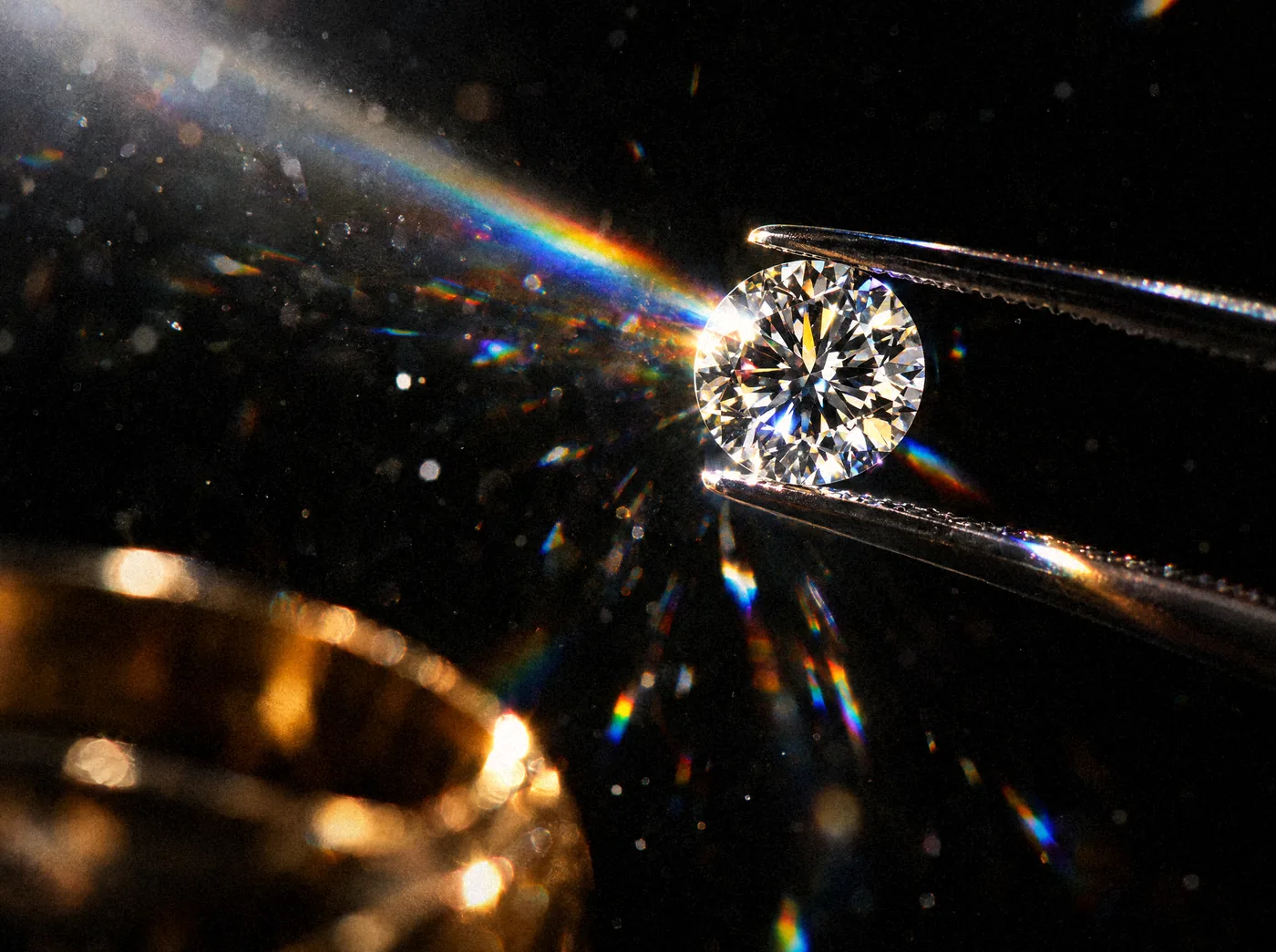 A lab-grown diamond held in tweezers, part of the cost to start a jewelry brand with lab-grown diamonds