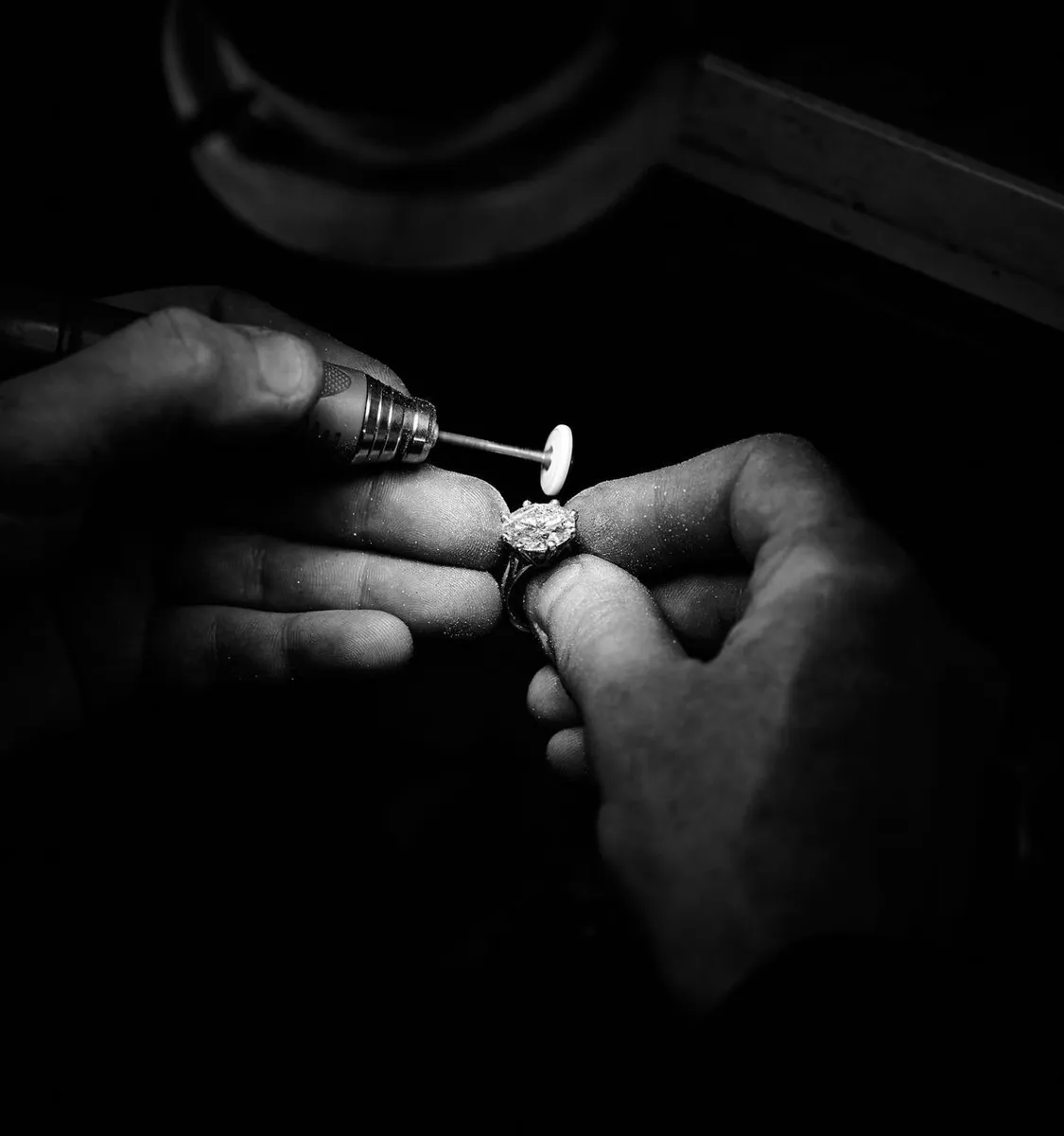 A jeweler setting a stone by hand in a partner workshop