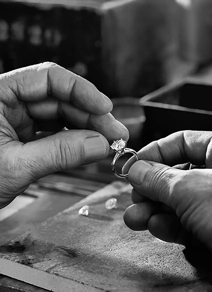 A finished ring checked against the sample at the bench